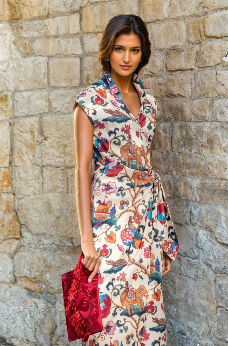 Close-up of the wrap dress showing the collared neckline and vibrant print, model holding a red clutch.