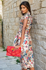 Side view of the printed midi dress highlighting the side-tie waist and back detailing.