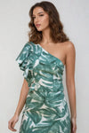 Close-up of ruffled one-shoulder design on green printed cotton-polyester top.