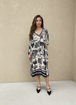 Model wearing black and ivory toile print dress with loose fit and long sleeves