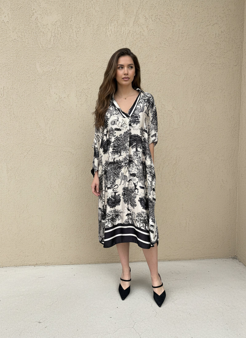Model wearing black and ivory toile print dress with loose fit and long sleeves