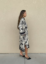Side profile of black toile print silk dress with relaxed fit and mid-length design