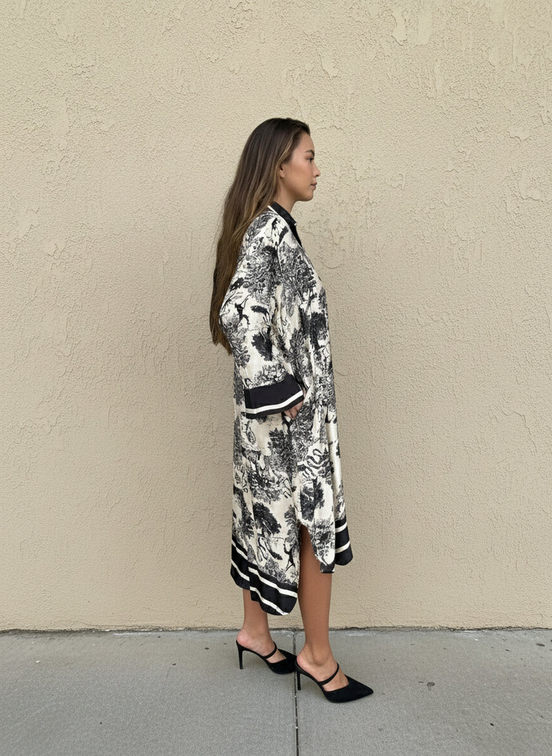 Side profile of black toile print silk dress with relaxed fit and mid-length design