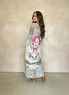 Back view of woman wearing animal print maxi dress featuring colorful artistic portrait and the phrase “I’ll Choose Courage,” styled with brown heeled boots.