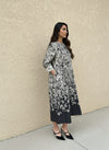 Side view of a model wearing a long floral monochrome dress with subtle pleats — minimalist yet elegant floral dress for everyday wear.