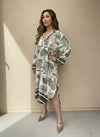 Side view of green toile pattern midi dress with flared hem and relaxed silhouette