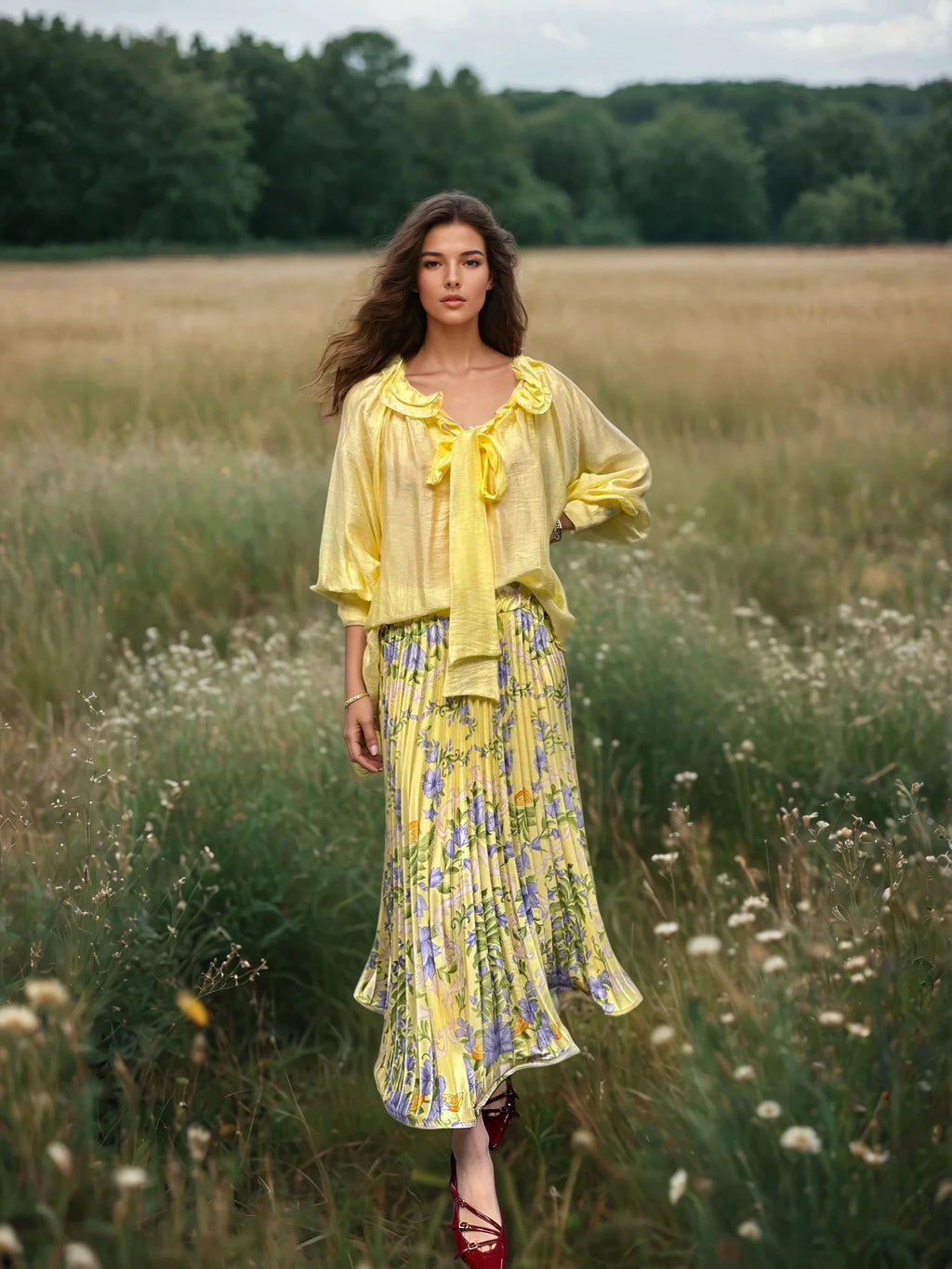Model walking through a wildflower field in a flowing yellow blouse and matching floral skirt, with wind in her hair.