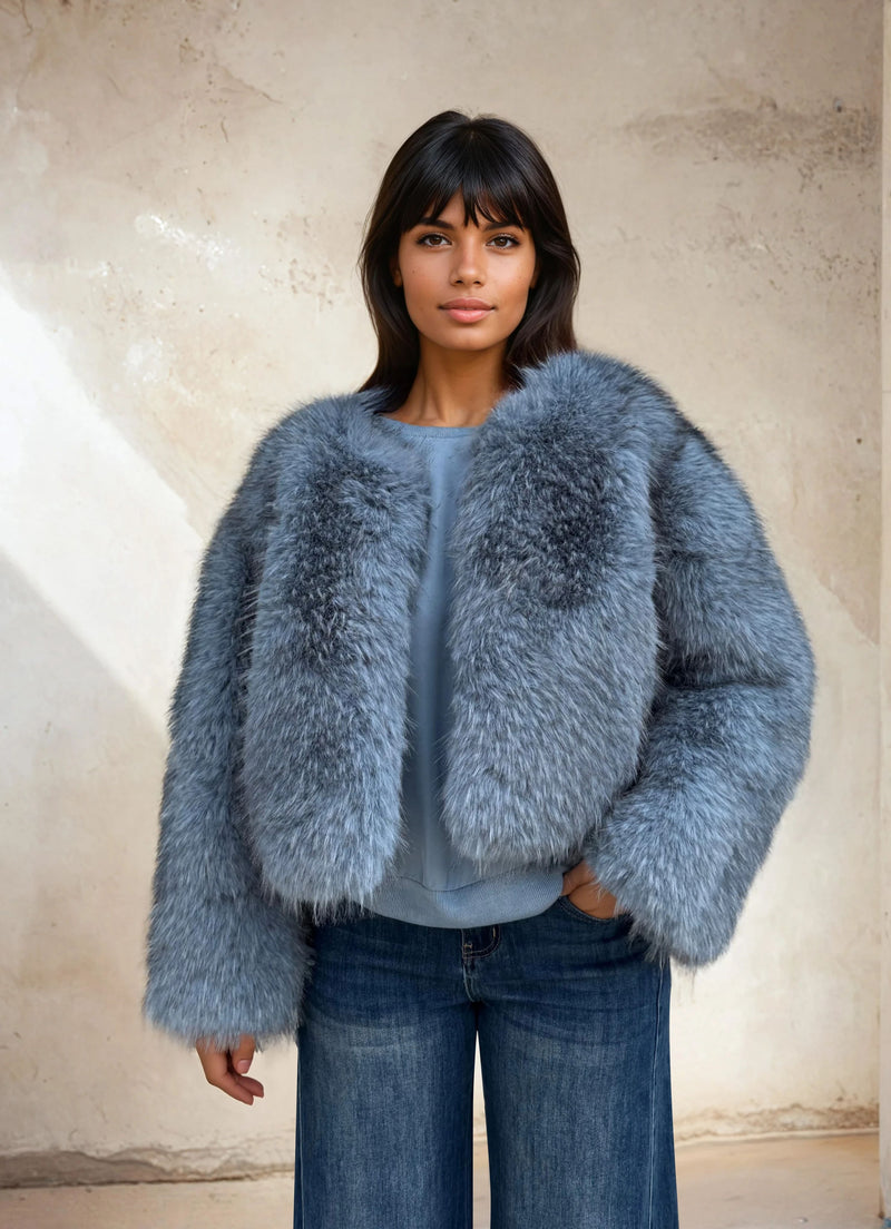 Close-up of a model in a sky-blue faux fur coat showing the soft fluffy texture and casual winter outfit.