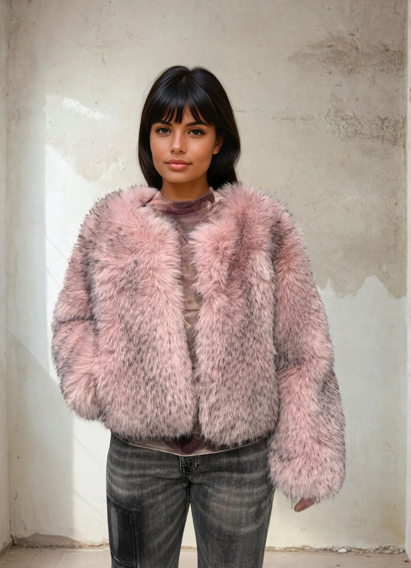 Close-up of a woman in a blush pink fluffy faux fur jacket highlighting the plush texture and warm tone.