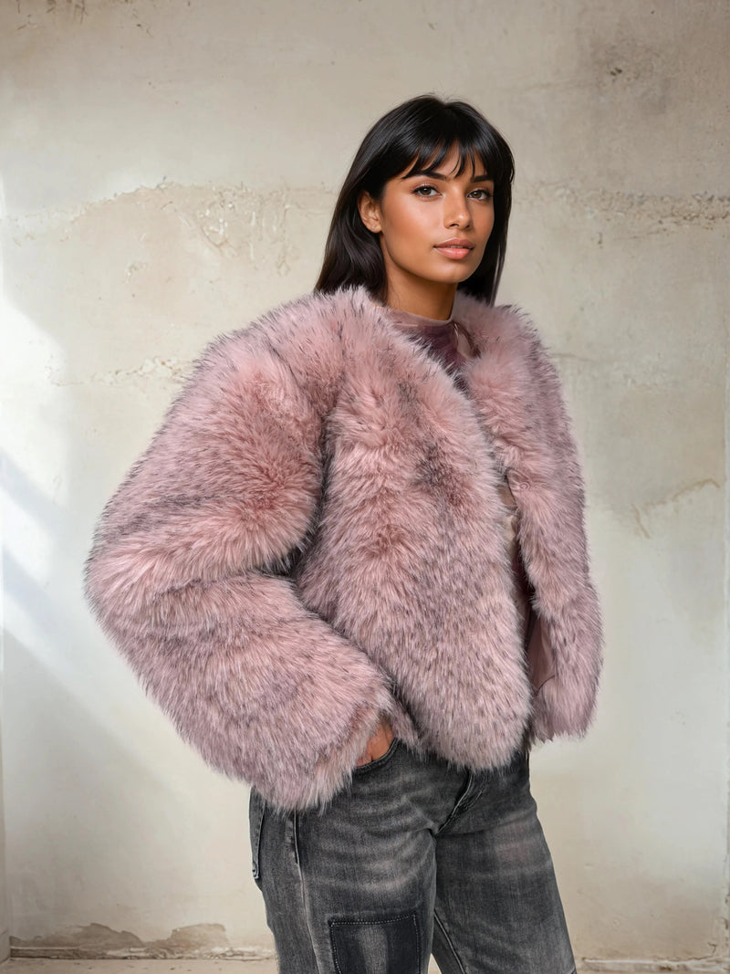 Side view of a pink faux fur jacket outfit paired with gray jeans for a stylish feminine winter look.
