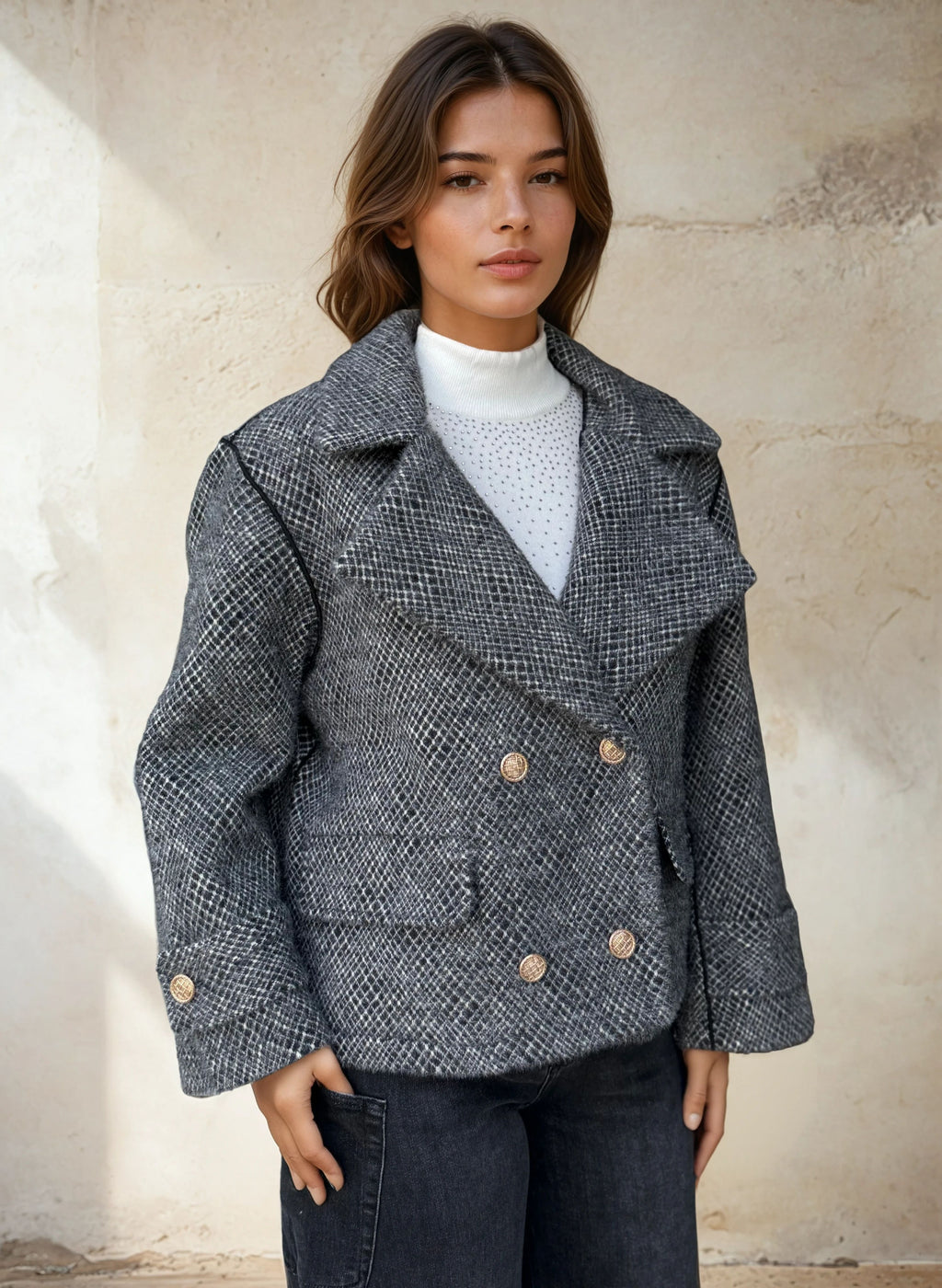 Woman wearing textured grey double-breasted peacoat with gold buttons.