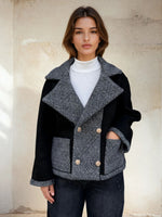 Model in two-tone jacket combining black suede and grey patterned panels.