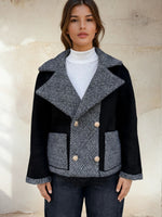 Front view of reversible-style jacket with contrasting black and grey textures.