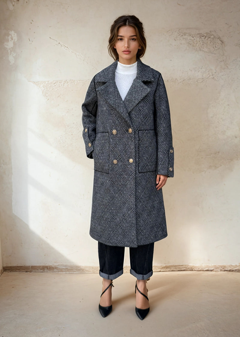 Model in a black gray double-breasted checkered wool coat with gold buttons, styled with rolled-up jeans and black pointed heels for minimalist winter fashion
