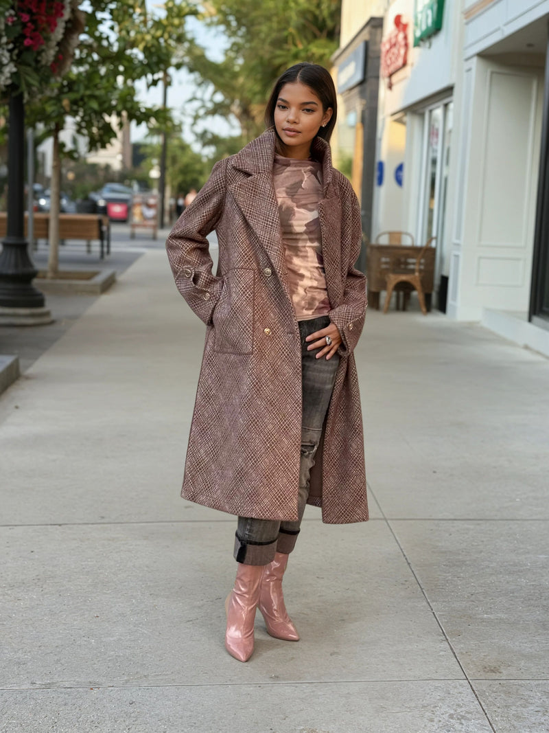 Model wearing a long brown textured wool coat with gold buttons, paired with distressed gray jeans and pink patent ankle boots, styled for fall street fashion