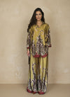 Front view of a woman in a chartreuse satin outfit with baroque floral detailing in burgundy and brown tones. Sophisticated coordinated set perfect for chic resort fashion.
