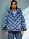 Front view of model in plush striped blue faux fur jacket with hood and zipper — modern cold-weather fashion