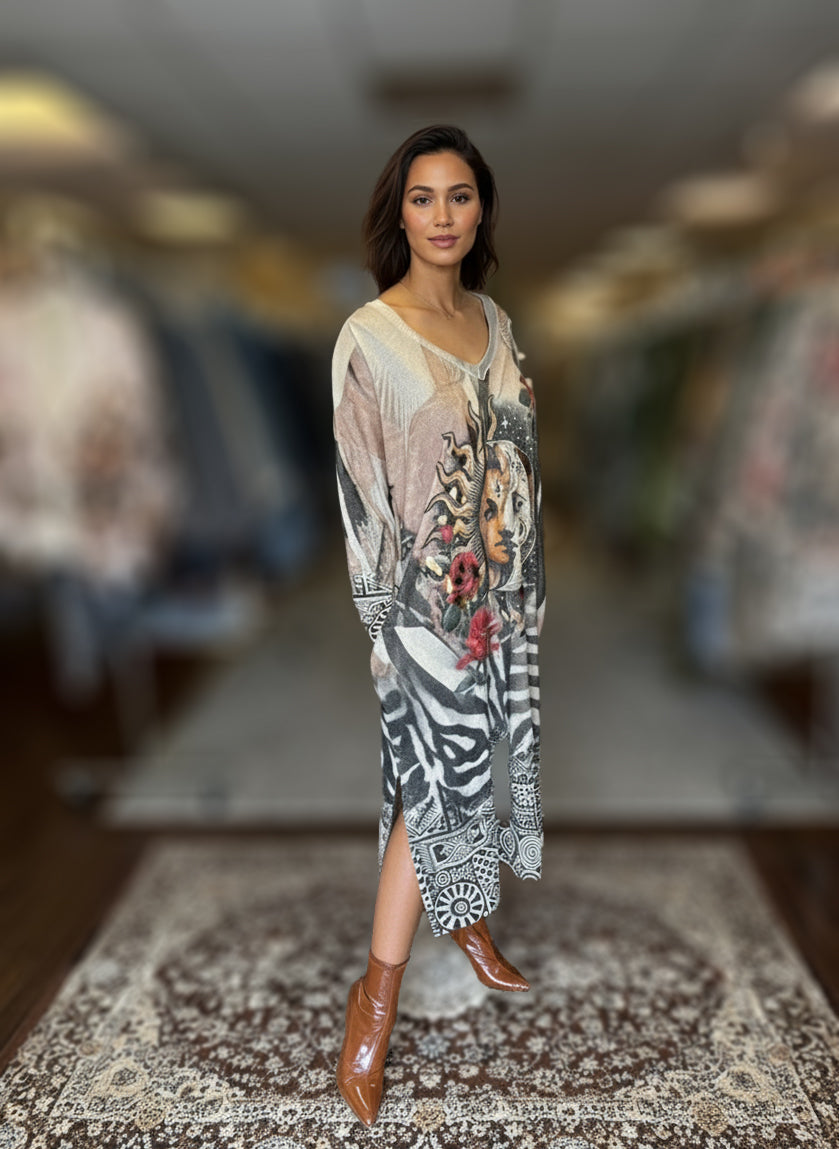 Woman wearing long bohemian-style maxi dress with celestial sun and moon print, zebra and geometric patterns, and red rose details, styled with brown ankle boots.